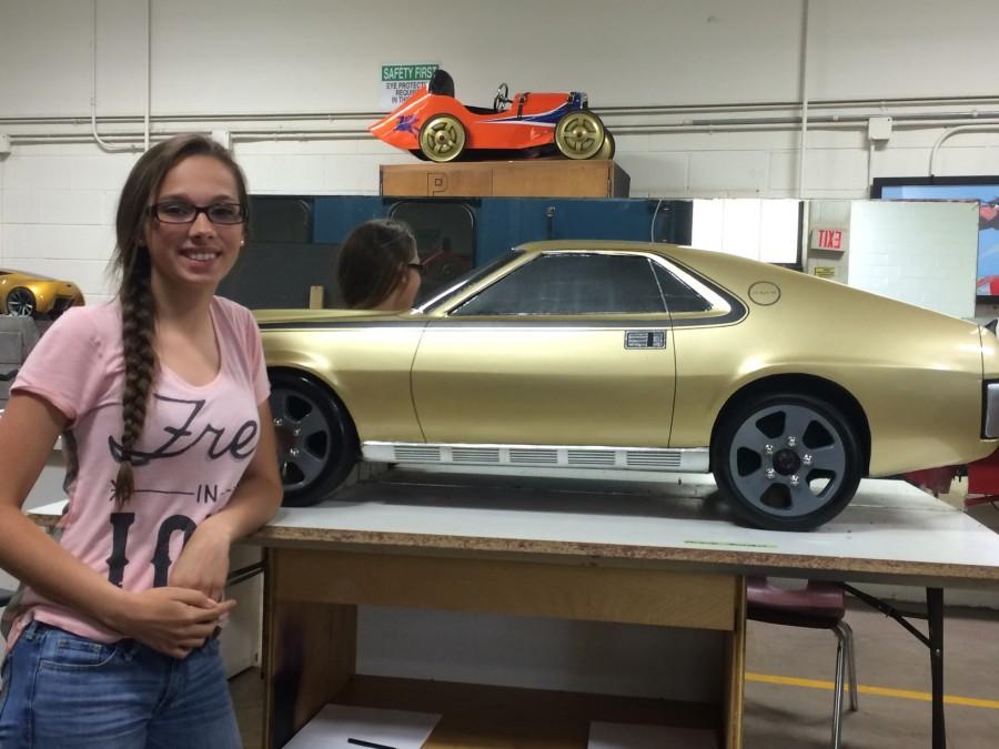 Freshman Miranda Rumfelt stands proudly next to her first place 1970 AMX.
