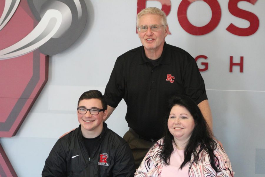 Mohn posing with his mom and new coach after signing with Rochester.
