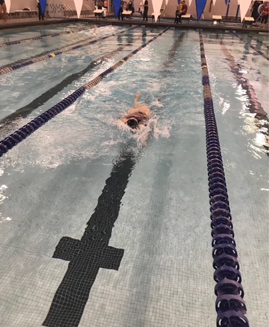 Junior Abby Barnett swimming backstroke in the 200 IM.