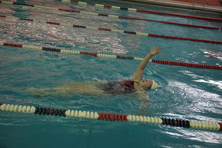 Junior Chloe LeBlanc swimming backstroke in the 200 IM