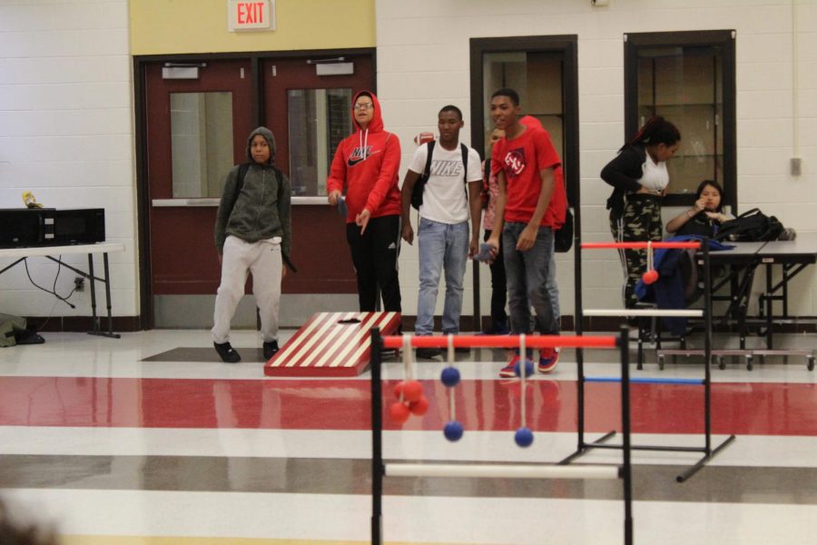 Freshmen join in on a game of bean bag toss.