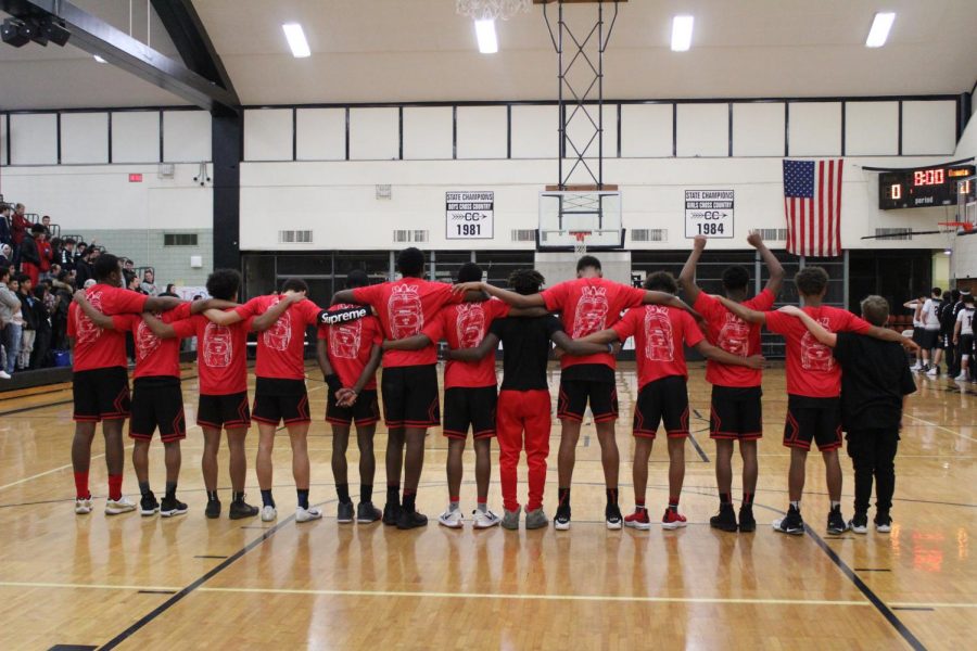 The team joining arms for the National Anthem.