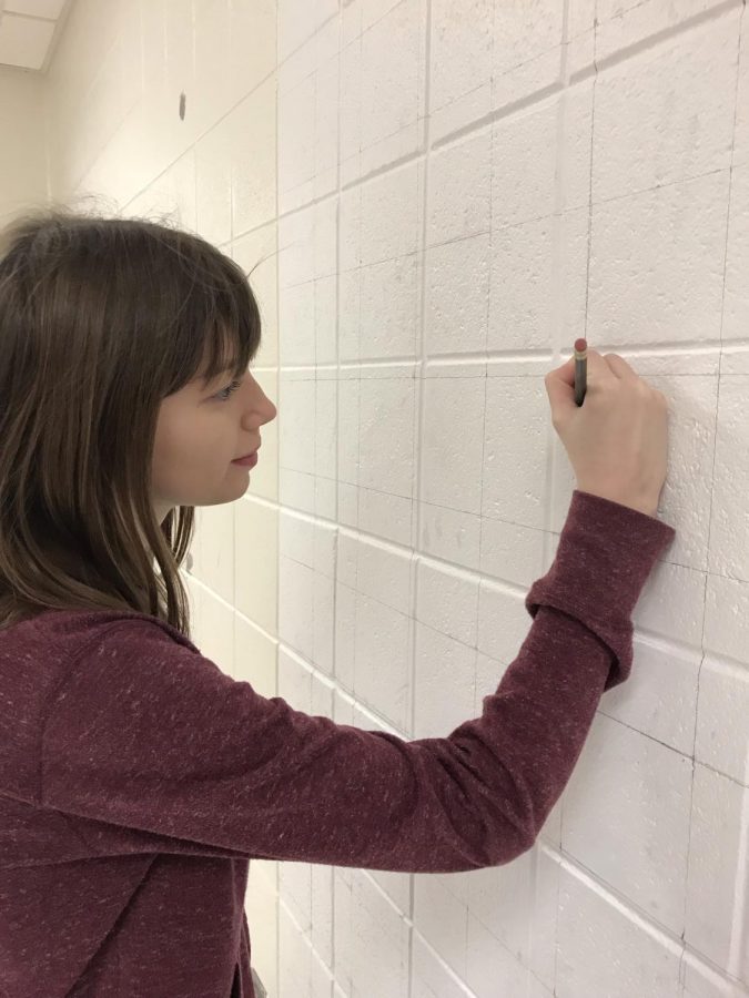 Senior Caitlyn Hudek continues to work on the grid for the mural.