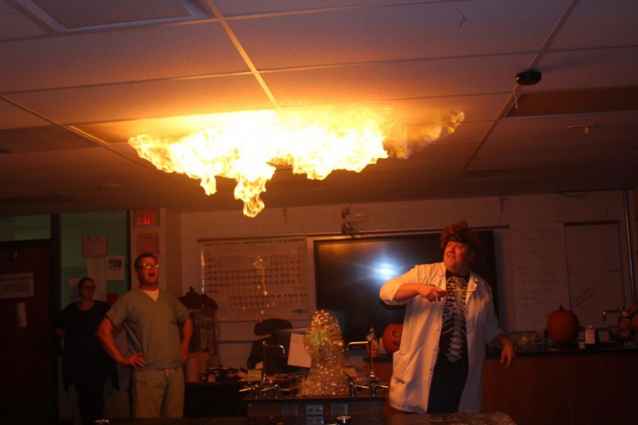 Biology teacher Bob Smitka lights bubbles in the air that cause a ripple effect across the ceiling.