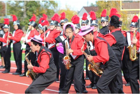 Saxophone section performed with fun hats to fire up the students.