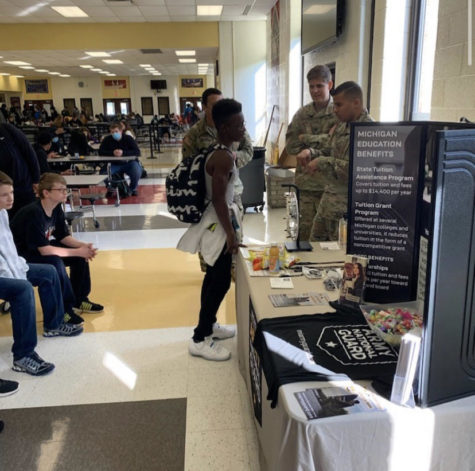 Staff Sergeant Joseph F. Brantley speaking to a student about the National Guard. 